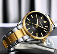 Montre Curren en métal deux tons or et argent, fond noir, pour hommes.