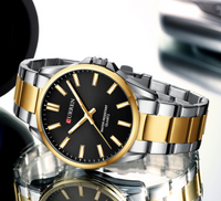 Montre Curren en métal deux tons or et argent, fond noir, pour hommes.